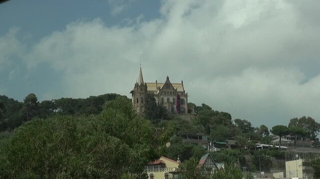 House hill mansion curious tower vane Barcelona modernism clouds sky