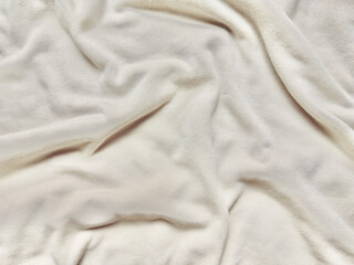 creamy white soft fabric texture rippling in elegant folds for minimalist wallpaper or serene banner background