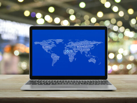 Start up 2026 business icon with global words world map on laptop computer screen on table over shopping mall, Happy new year 2026 start up online concept, Elements of this image furnished by NASA