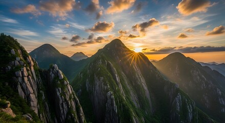 Sunset over a rugged mountain range with vibrant sky and clouds