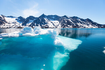 Melting icebergs by the coast of Greenland, on a beautiful summer day - Melting of a iceberg and pouring water into the sea - Greenland © muratart