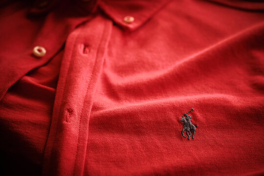 Red Polo Ralph Lauren featherweight mesh shirt decorated with embroidered equestrian logo. Illustrative editorial photo
