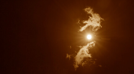 sky with clouds and sun reflection. sun shines bright in the daytime in summer Rays of light shining in blue sky clouds Sun light rays or beams bursting from the clouds on yellow red golden heaven