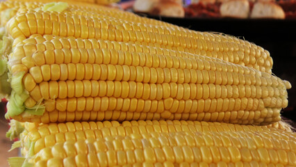 Fresh peeled sweet corn stacked in a street food stall