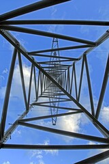 Power transmission tower against blue sky perspective view