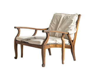 Ornate wooden armchair with plush cream cushions on a black background