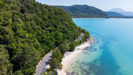 Aerial view of the scenic coastal road in between Daintree and Mossman, where the Daintree Rainforest meets the Great Barrier Reef in Tropical North Queensland, Australia.  © pauline.mongarny