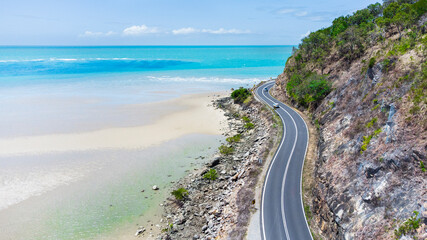 Aerial view of the scenic coastal road in between Daintree and Mossman, where the Daintree Rainforest meets the Great Barrier Reef in Tropical North Queensland, Australia.  © pauline.mongarny