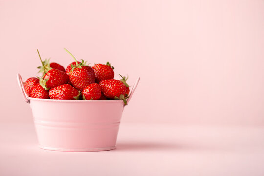 Ripe Strawberries on Pastel Pink Background