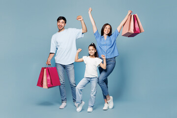 Full body young parents mom dad with child kid daughter girl wear casual clothes hold shopping...