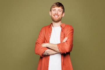 Smiling happy fun Caucasian young man he wears basic white t-shirt orange shirt look camera hold...