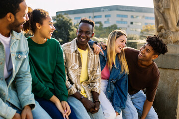 Young group of happy millennial student people laughing together outdoor. Friendship and youth...