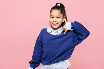 Little child kid girl 8-9 years old she wear blue shirt have fun doing phone gesture like says call me back isolated on pastel light pink background studio. Mother's Day love family lifestyle concept