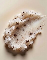 Hyper-realistic studio photography of cosmetic textures, swatch of a white sugar scrub with coffee grounds
