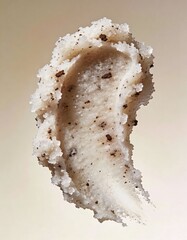 Hyper-realistic studio photography of cosmetic textures, swatch of a white sugar scrub with coffee grounds