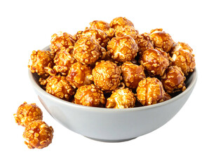 A white bowl overflowing with caramel-coated popcorn, isolated on a black background