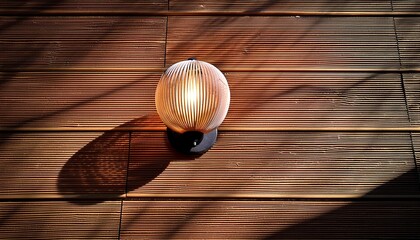 Fototapeta premium Modern Wall Sconce On Wooden Slatted Wall With Strong Shadow