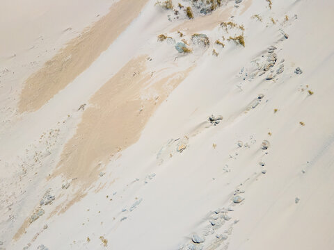 Aerial view of the stark, beige and white patterned landscape with linear striations and textured features, Betty's Bay, South Africa