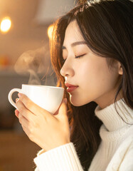 Serene young woman enjoying a steaming cup of morning coffee