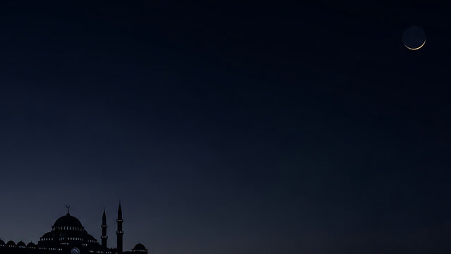 Silhouette of a mosque with domes and minarets against a dark blue night sky with a crescent moon.