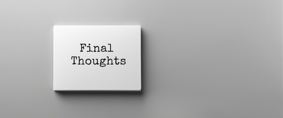 Closing Remarks text on a white notebook, front perspective against a gray backdrop