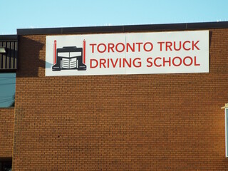 Obraz premium Ottawa, ON, Canada-July 7,2025: A white sign on a brick building for 