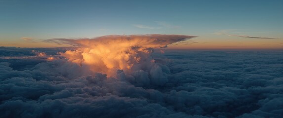 Aerial shot of sunset clouds casting striking shadows, viewed from an airplane