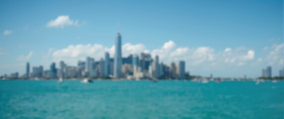 Fototapeta premium Urban buildings' silhouette with blurred effect and sea backdrop