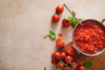 Homemade tomato sauce in an authentic bowl on light background. Chopped tomatoes for italian sauce. Top view. Copy space.