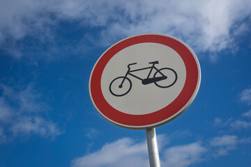 Cycle path sign against a blue sky