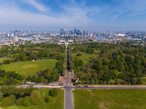 Aerial view of verdant expanses meet the modern skyline, juxtaposing nature's calm with the city's vibrant pulse, revealing the iconic dome of the O2 Arena, London, England, United Kingdom.
