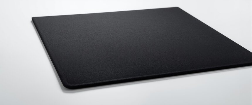White background featuring a computer mouse pad made of thick fabric