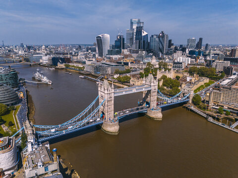 Aerial view of the iconic Tower Bridge spanning the tranquil Thames, framed by the modern skyscrapers of London's skyline, London, Greater London, United Kingdom.
