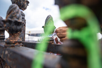 Close-up of hands on a grid with ribbons and a rosary