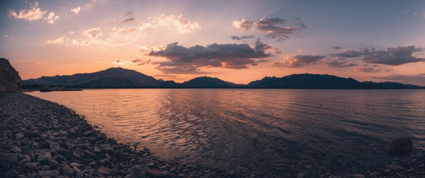 Lake landscape featuring rocky shores and mountain backdrop at Borovoe resort, Kazakhstan