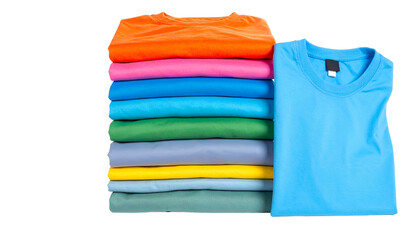 A stack of folded colorful t-shirts, arranged next to a single unfolded blue one