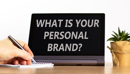 What is your personal brand symbol. Concept words What is your personal brand on black tablet. Beautiful white background. Businessman's hand. Business what is your personal brand concept. Copy space.