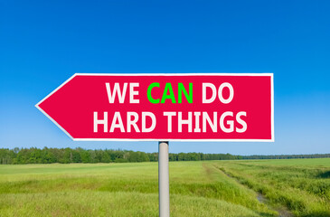 Support, help we can do hard things symbol. Concept words We can do hard things on beautiful red road sign. Beautiful blue sky field background. Business we can do hard things concept. Copy space.