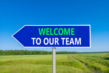 Support, help welcome to our team symbol. Concept words Welcome to our team on beautiful blue road sign. Beautiful blue sky green field background. Business welcome to our team concept. Copy space.