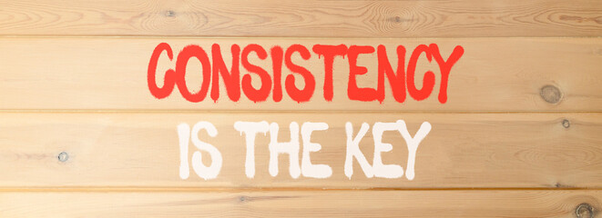 Consistency is the key symbol. Concept words Consistency is the key on beautiful wooden wall. Beautiful wooden wall background. Business consistency is the key concept. Copy space.