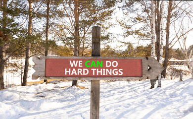Support, help we can do hard things symbol. Concept words We can do hard things on beautiful wooden road sign. Beautiful winter forest background. Business we can do hard things concept. Copy space.