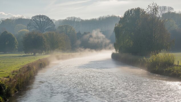 Godalming's River Wey fog disperses on a chilly sunny morning, atmospheric weather, Earth Day