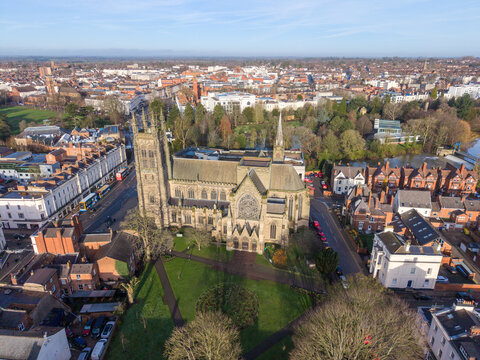 Aerial view of a majestic church standing tall amidst the town's tapestry, its spires reaching towards the heavens, Royal Leamington Spa, England, United Kingdom.