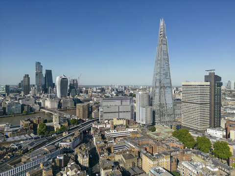 Aerial view of The Shard piercing the sky, a modern spear amidst the historic cityscape, with the Tower Bridge a timeless sentinel over the Thames, London, London, United Kingdom.
