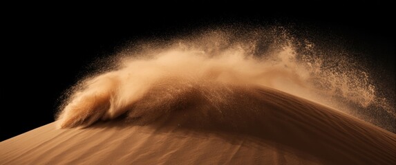 Sand dune hill under wind storm with dust splash and flying particles in the afternoon sunshine