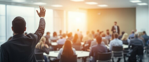 Person in business attire with hand raised at conference