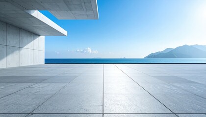 Sleek concrete architecture overlooking a tranquil ocean with a clear blue sky, embodying modern minimalism and coastal serenity.