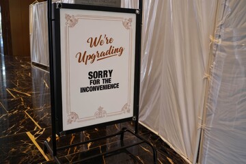  A standing sign with text “We’re upgrading, sorry for the inconvenience”.