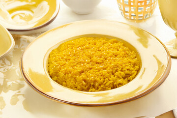 Milanese saffron risotto served in a rustic plate