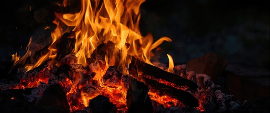 Wood chips burning to produce coal for barbecue, fire setup prior to cooking, heated wood forming hot coal
